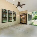 Porch addition with ceiling fan and large windows