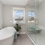 Modern bathroom remodel with soaking tub and glass shower