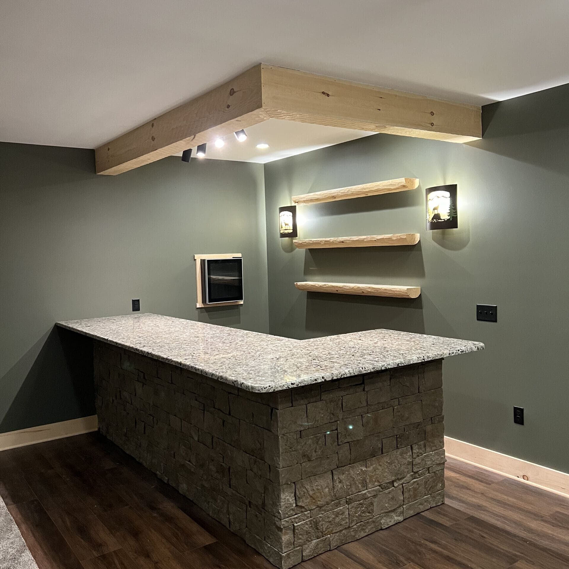 Basement bar with stone base and wood countertop